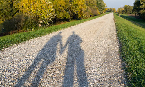 Shadow of a Couple on the Dirt Road in the Nature